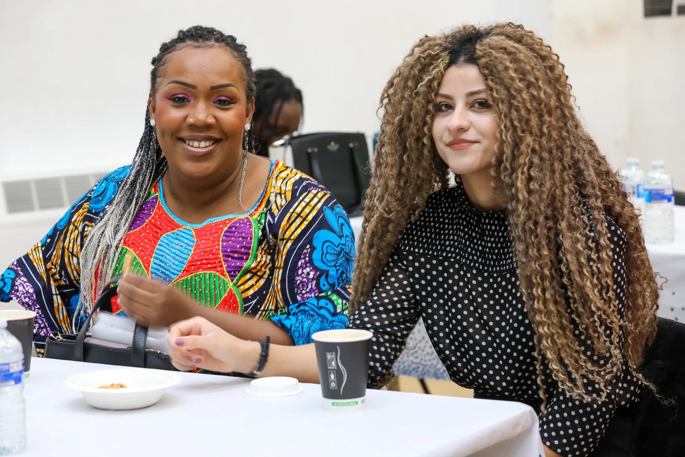 Two Project ME participants in conversation at a shared table