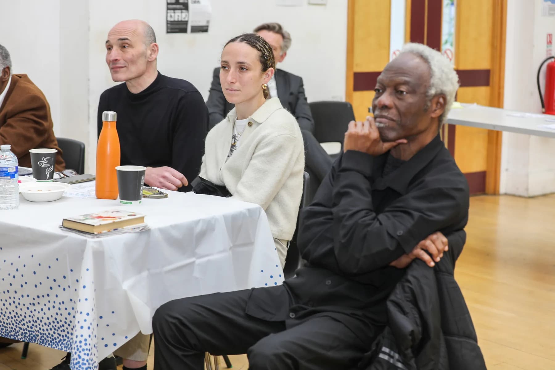 Guests listening from a table at the Project ME celebration