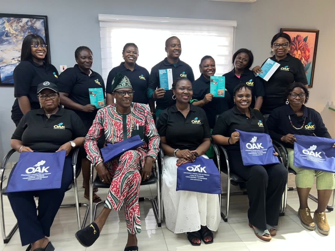 OAKonsult outreach team members gathered together with programme materials